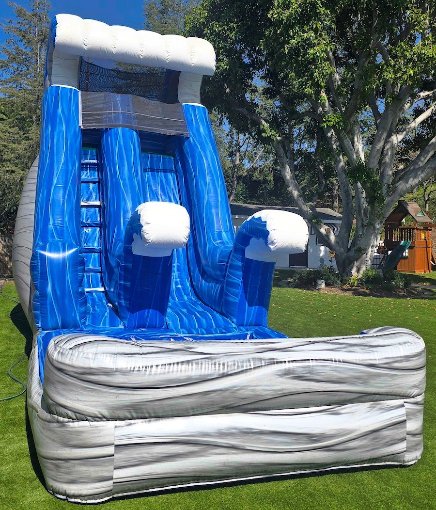 Wave-patterned water slide inflatable from a different angle or setup view.