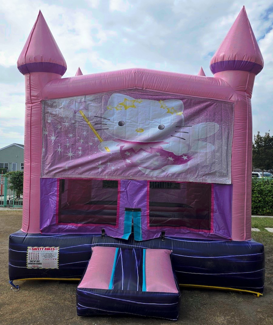 Pink castle inflatable from alternate angle showing entrance and design details