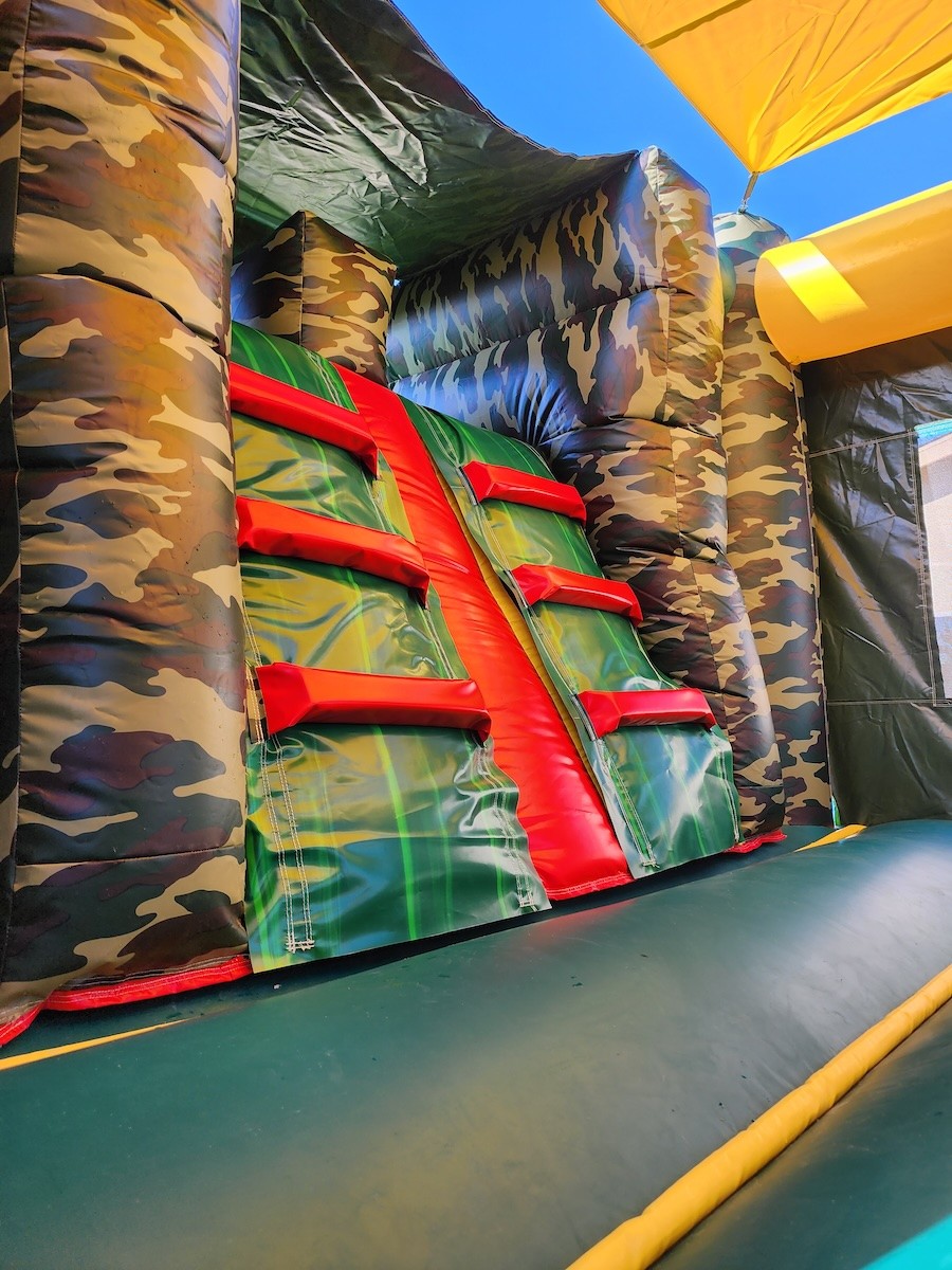 Camouflage-themed combo bounce house with jumping and play areas
