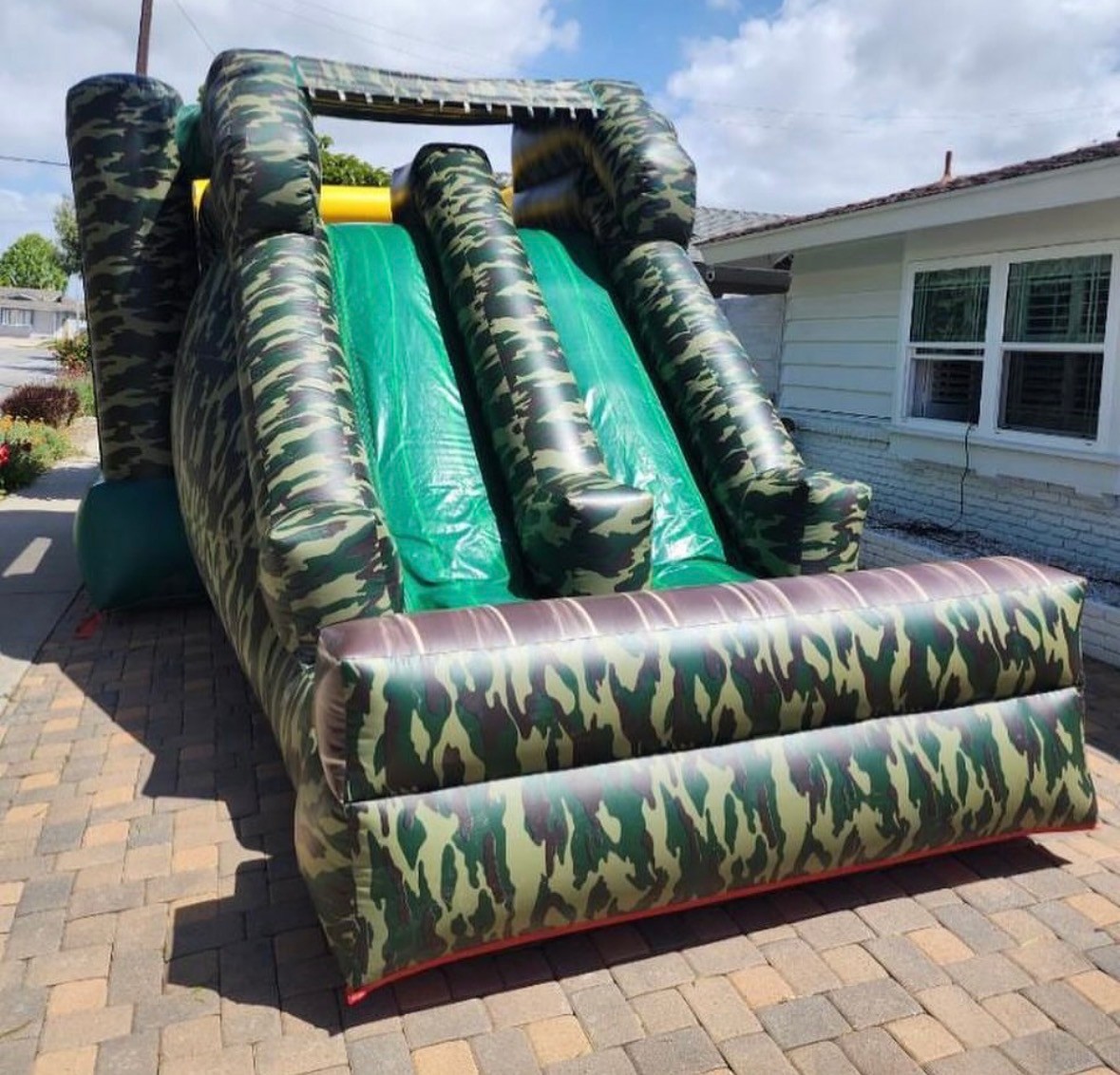 Camouflage-themed combo bounce house with jumping and play areas