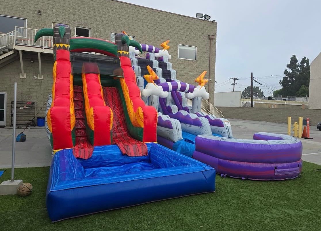 Tropical themed water slide inflatable with red, yellow, and green colors